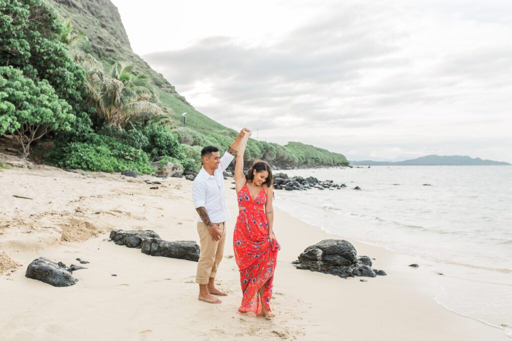couple dancing on beach in engagement photos