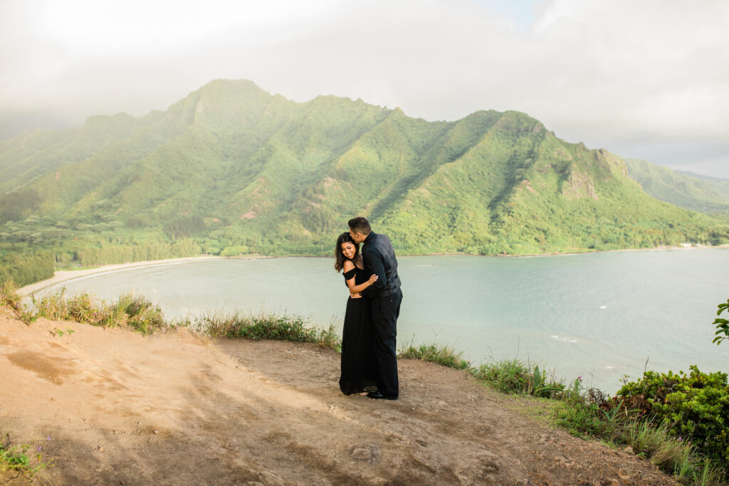 engaged couple kissing on top of mountain in hawaii