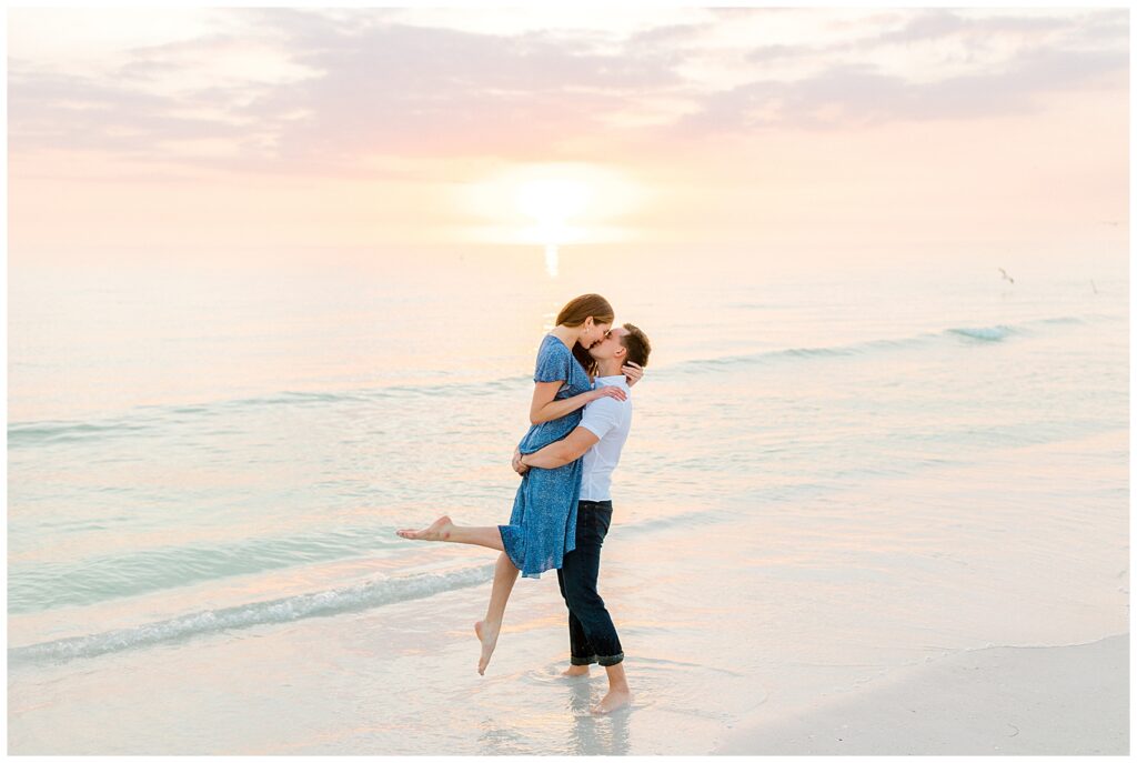 couple posing for engagement photos on florida beach